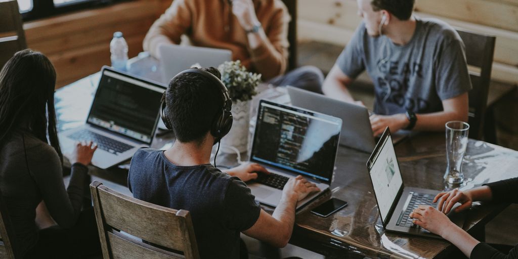 group of people using laptop computer