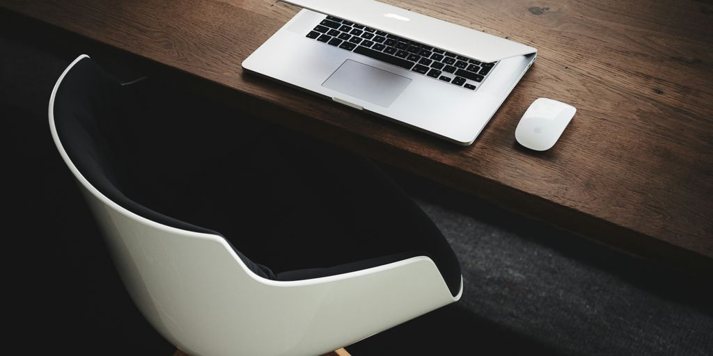 Apple MacBook beside computer mouse on table