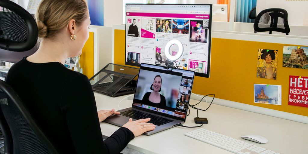 a woman sitting at a desk with a laptop computer